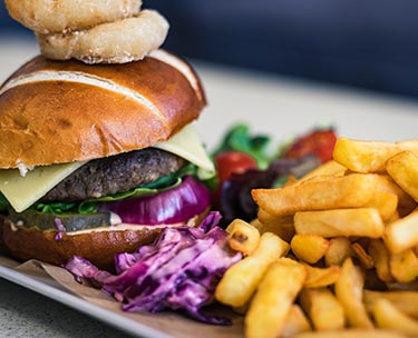Close up photograph of a delicious burger and chips